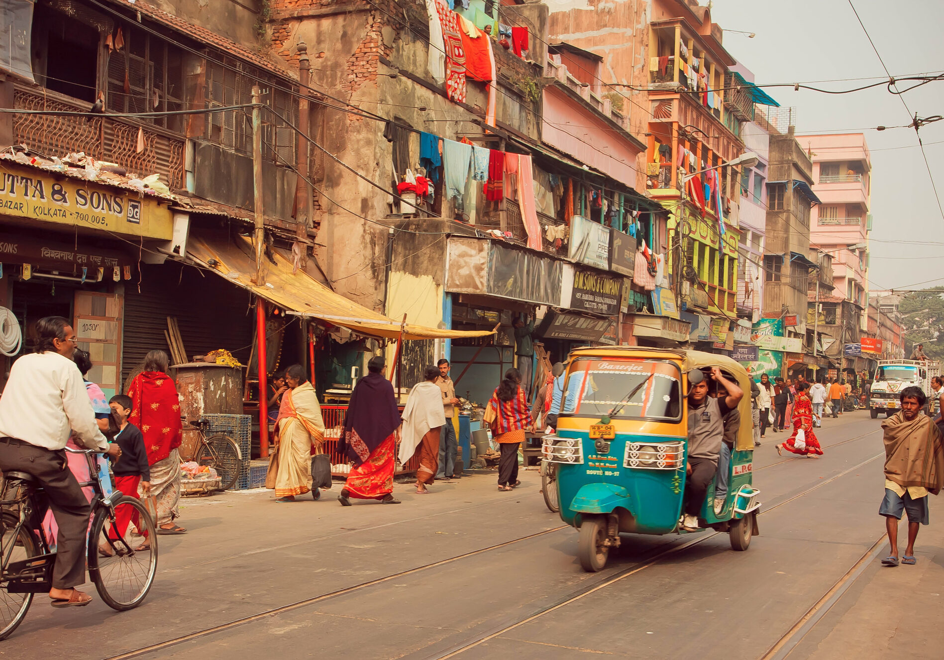 KOLKATA, INDIA - JAN 11: Autorickshaw in indian style driving through busy city street on January 11, 2016 in Calcutta. Kolkata has a density of 814.80 vehicles per km road length