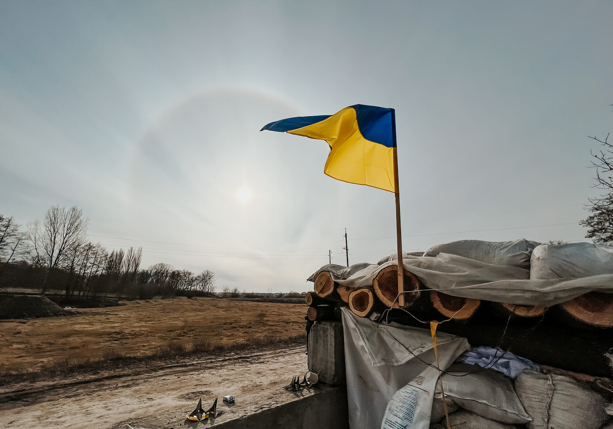 12.03.2022 Irpin, Ukraine: self-made checkpoint at the entrance to the village to check cars and detect saboteurs or stop enemy vehicles. The yellow and blue flag of Ukraine is hoisted over the post